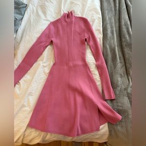 Pink sweater Dress. Long sleeve turtle neck sweater dress in pink. Small slit.